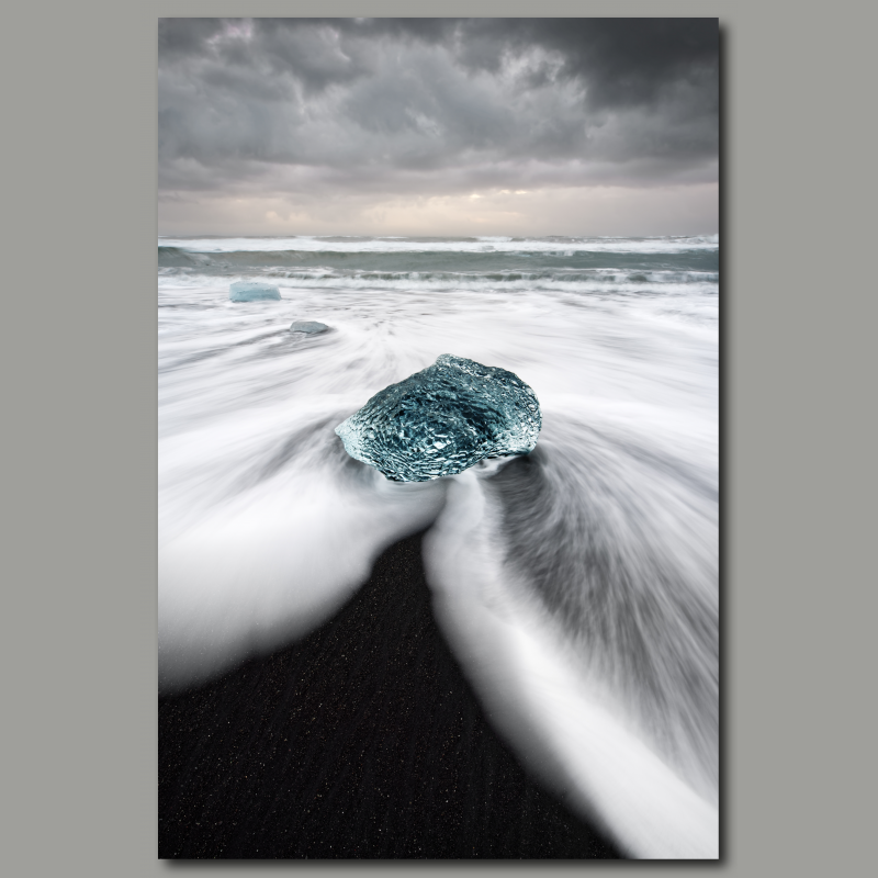 Poster: Schwarzer Strand mit Eisblock